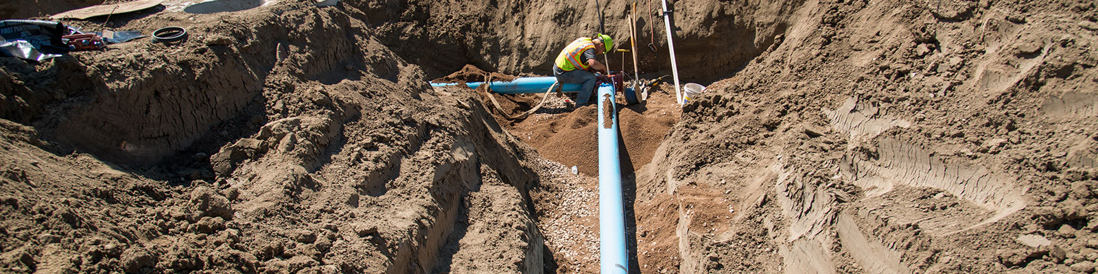 Water pipes being installed as part of a Minot construction job